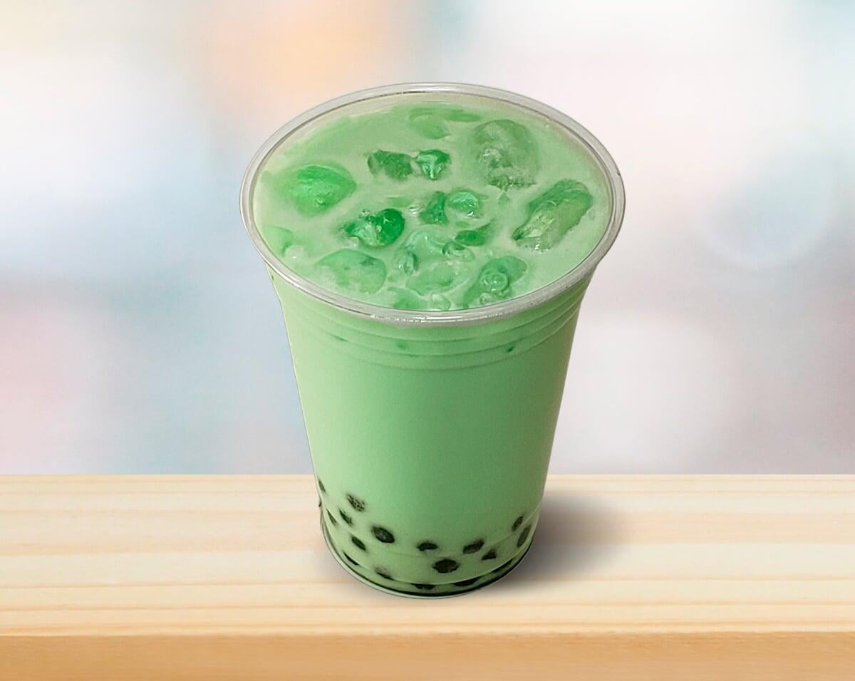 photo of honey dew boba tea over ice